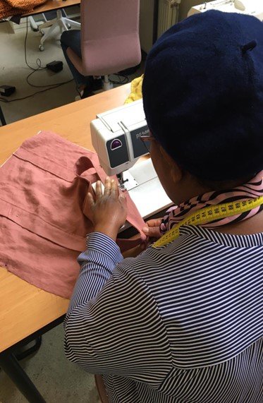 Dame aan het werk in het naaiatelier van de Wereldwijven